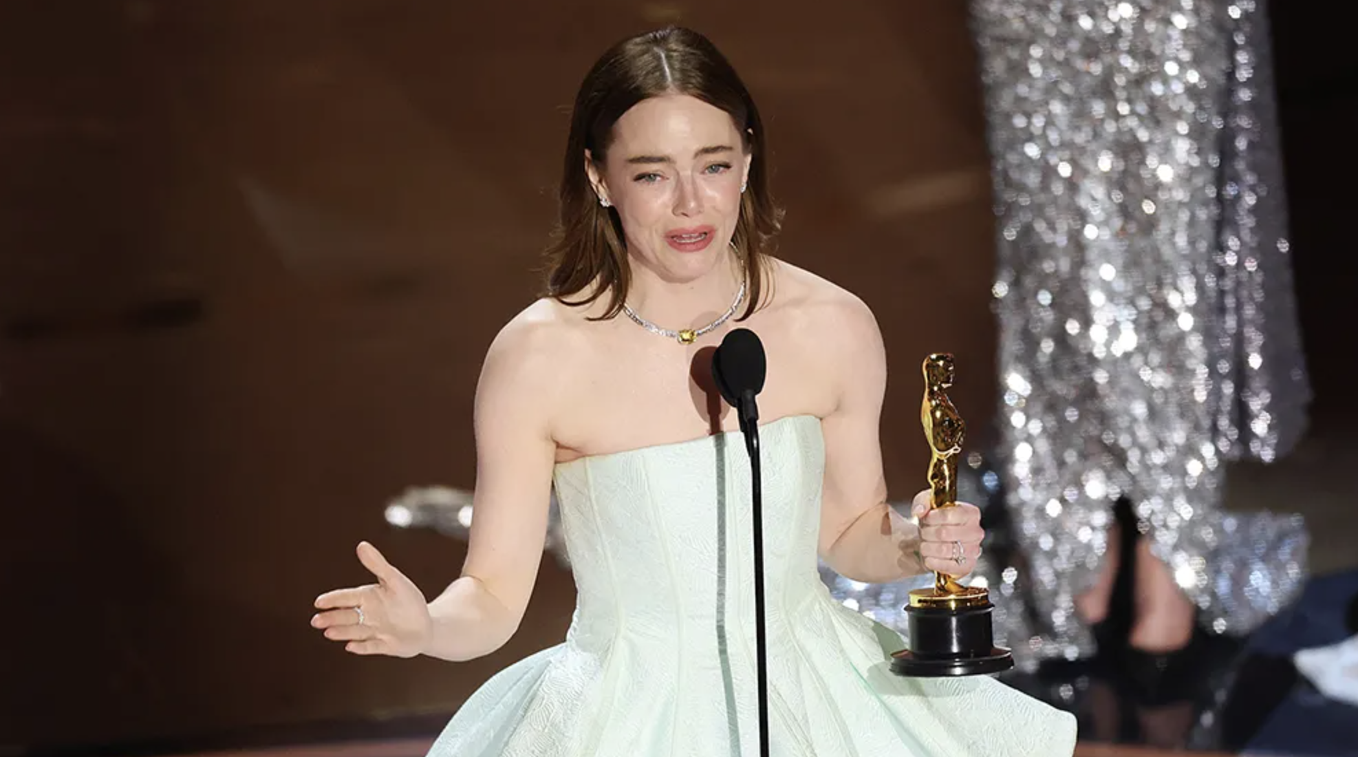 Emma Stone Takes Best Actress Oscar in ‘Broken’ Gown, Jokes: “No Peeking at the Back!”